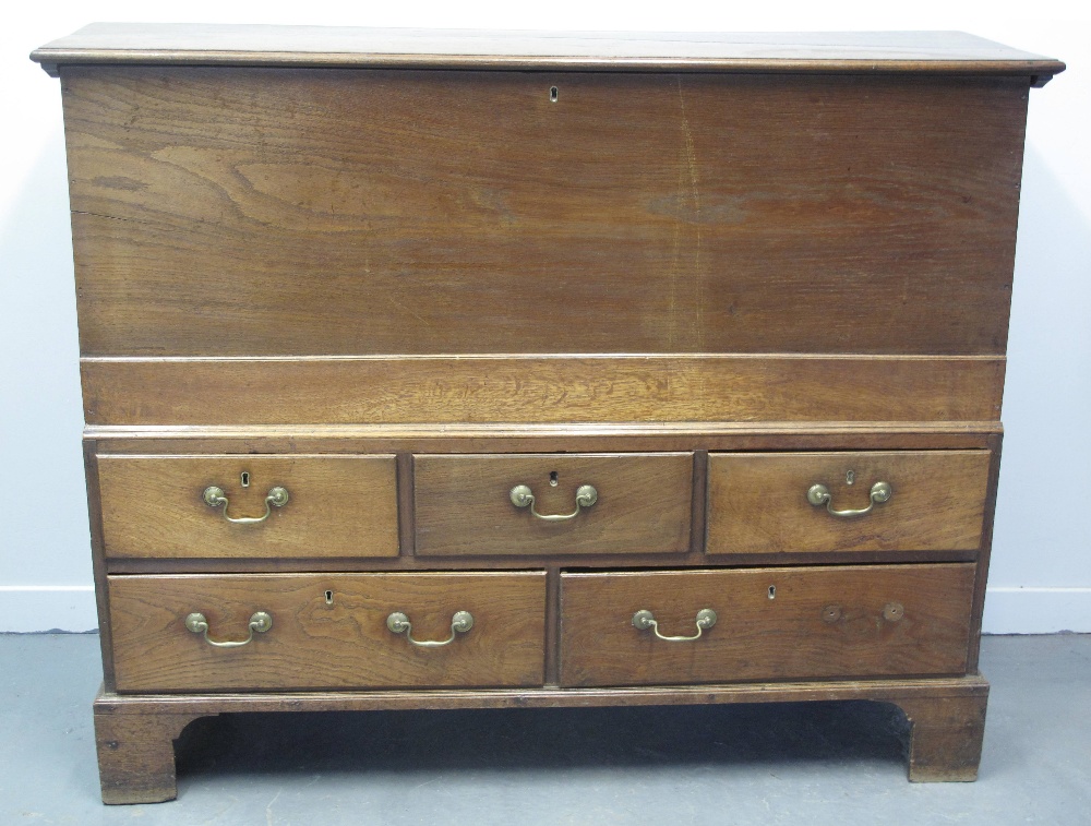 EARLY 19TH CENTURY WELSH OAK ONE PIECE MULE CHEST, having hinged, moulded top over plain front,