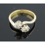 18CT GOLD PLATINUM MOUNTED TWO STONE DIAMOND RING. The brilliant cut diamonds claw set on a twist.