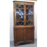 EARLY 19TH CENTURY WELSH OAK DOUBLE CORNER CABINET, having moulded and geometrically inlaid frieze