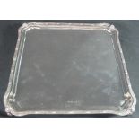 SILVER SQUARE SHAPED SALVER with Celtic design rim standing on four ball feet. Birmingham