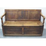 LATE 19TH CENTURY PEMBROKESHIRE PINE SETTLE, having three panelled back with scrolled open arms on