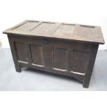 18TH CENTURY OAK FOUR PANEL COFFER, the panelled lid on later hinges, original iron lock plate but