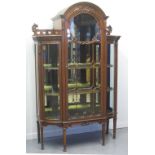 EARLY 20TH CENTURY WALNUT DISPLAY CABINET, having arch glazed centre door flanked by two curved