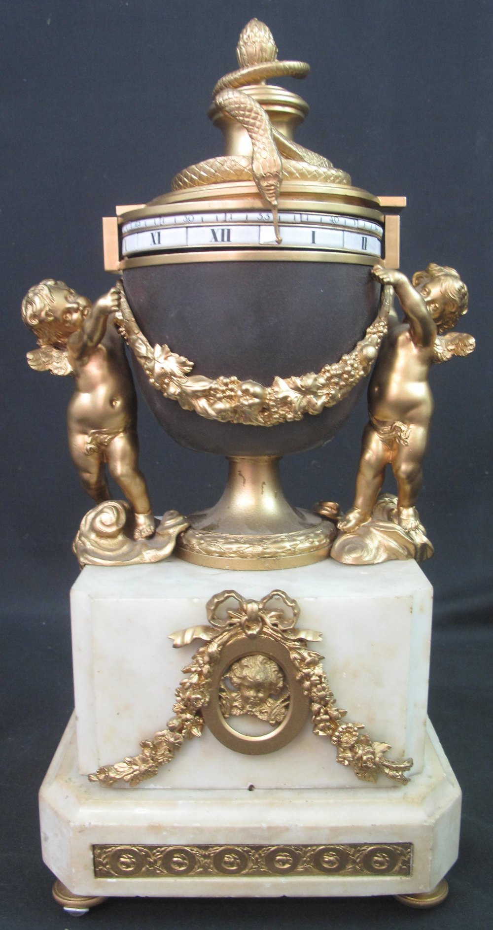 FRENCH ORMOLU AND WHITE MARBLE 'CERCLE TOURNANTS' URN SHAPED, CHERUB MOUNTED MANTEL CLOCK,