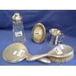 Group of assorted silver items to include: vanity brush; mirror; oval photograph frame;