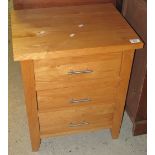 Modern light oak, narrow, straight fronted bedside chest with three drawers. (B.P. 24% incl.