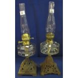 Two similar early 20th Century brass double burner oil lamps with clear glass reservoirs and