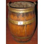 Coopered barrel shaped bucket on stick stand with iron swing handle. 41cm high. (B.P. 24% incl.