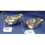 Two similar scroll handled silver sauce boats, both Birmingham hallmarks,