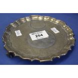 Small silver pie crust edge salver raised on three scroll feet, London hallmarks, 7 Troy ozs approx.