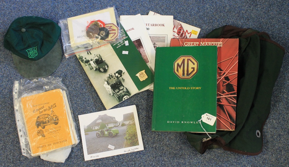 MG green bag containing assorted books, badges, cap and other MG ephemera, MMM yearbook 2000,