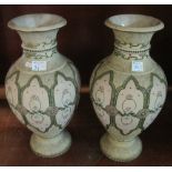 Pair of Japanese enamelled pottery, baluster shaped pedestal vases with stylised panel decoration,