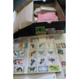 Shoebox of All World stamps in three albums, packets and envelopes. Many hundreds. (B.P. 24% incl.