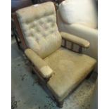 Edwardian mahogany button back upholstered armchair on ring turned, tapering legs and brass casters.