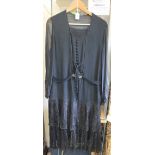 Black silk and lace vintage 1920's long sleeved belted flapper dress with a row of buttons down the