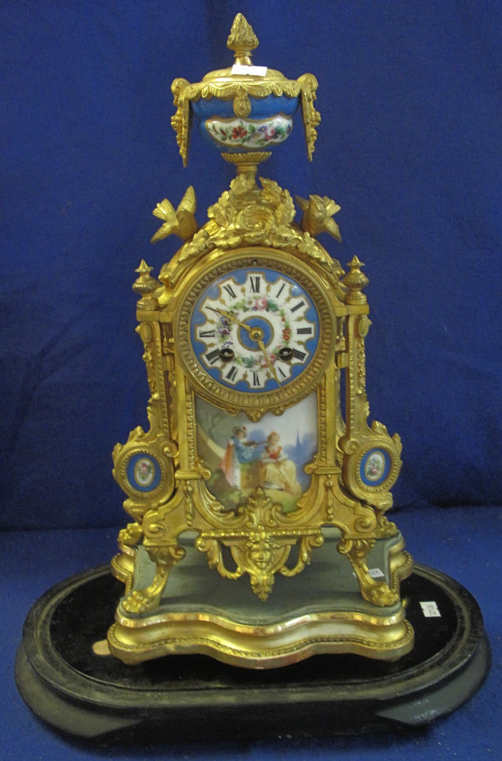 19th Century French Ormolu architectural mantel clock with porcelain, urn shaped finial,