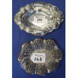 Two white metal oval bonbon dishes, one pierced with scroll decoration. (2) (B.P. 24% incl.