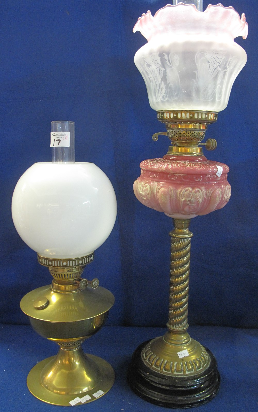 Early 20th Century brass double burner oil lamp with graduated repousse glass reservoir,