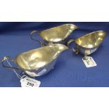 Three similar silver sauce boats with pie crust edges raised on three hoof feet,