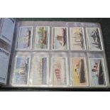 Range of cigarette cards in blue album.