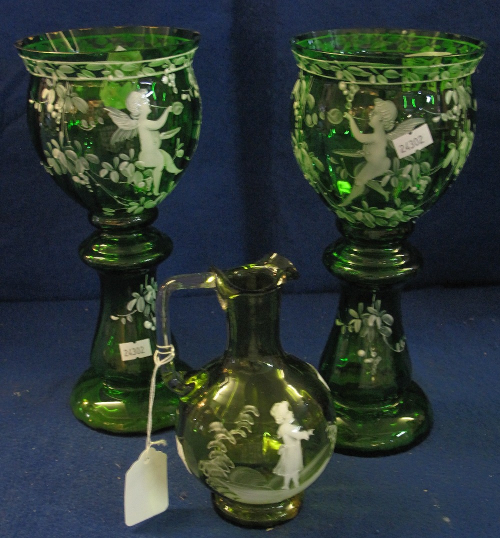 Pair of Mary Gregory type enamelled green glass, urn shaped vases on stands with cherub decoration,