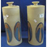 Two similar Laugharne pottery stoneware cylinder vases and covers with glazed panels. (2) (B.P.