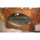 Early 20th Century oak oval bevel plate mirror with bobbin mouldings and other decoration. (B.P.