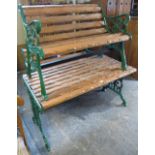 Pair of slatted garden benches with scroll decorated cast iron supports,