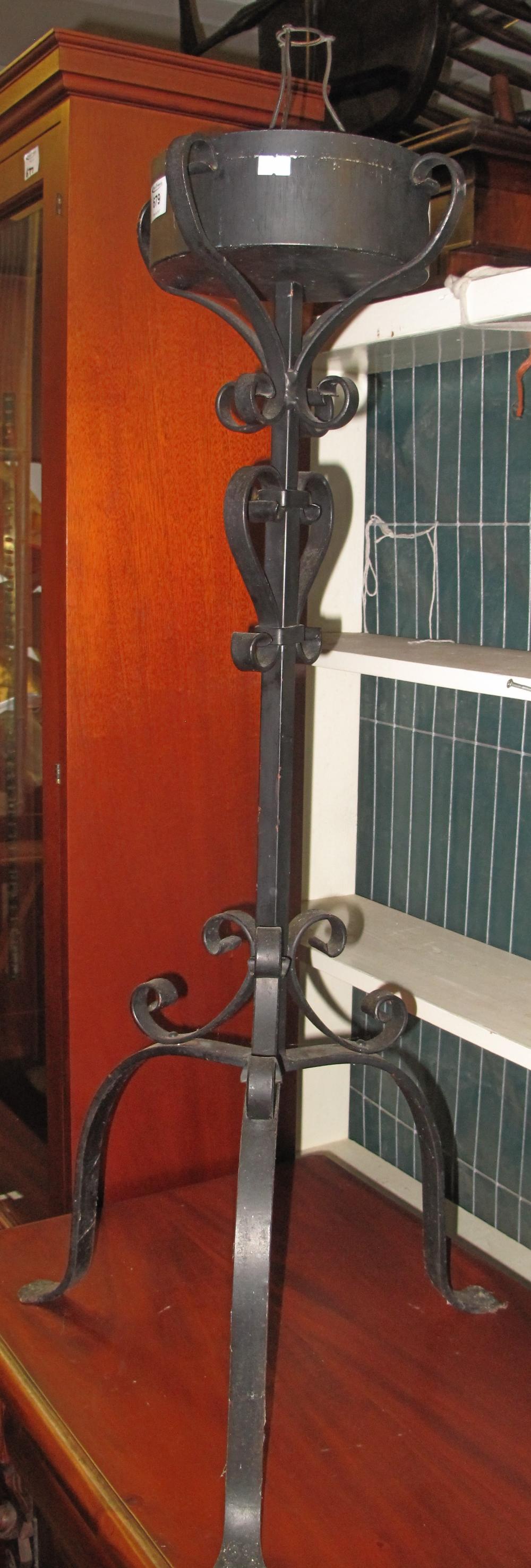 Wrought iron scroll decorated planter on triform base. (B.P. 24% incl.