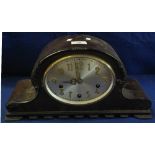 Early 20th Century mahogany arch topped three train mantel clock with silvered Arabic face,