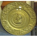 Large repousse brass circular plaque with portrait centre and foliate fleur de lis border. (B.P.