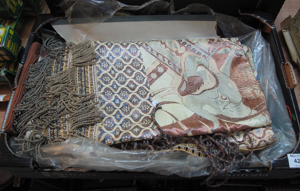 Box containing various fabrics including a gold embroidered throw of Asian design,