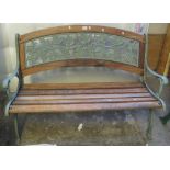 Oak slatted garden bench with cast metal supports and fruit and foliate decoration. (B.P. 24% incl.