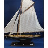 Model yacht, possibly Columbia, on platform base. (B.P. 24% incl.