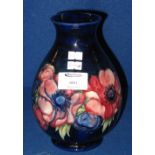 Moorcroft Pottery baluster vase, having ovarall tube lined stylised flowers on a cobalt blue ground,