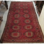 Middle Eastern red ground rug, panel design on red ground with geometric border, 211 x 108cm. (B.P.