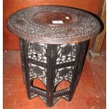 Eastern design carved hardwood occasional table with circular brass inlaid top and folding