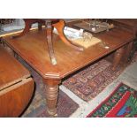 Edwardian walnut extending dining table with canted angles on baluster turned and fluted legs. (B.