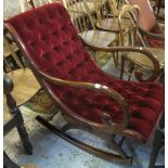 Victorian style mahogany button back upholstered rocking armchair with carved fan decoration. (B.P.