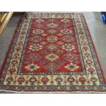 Middle Eastern red ground geometric design rug, 139 x 178cm. (B.P. 24% incl.