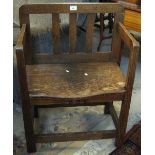 20th Century oak stick back type open armchair. (B.P. 24% incl.