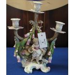 Continental porcelain three branch candelabrum depicting young girl with animals and fruit,