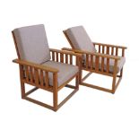 A pair of beechwood Morris style reclining armchairs, probably English mid 20th century. One with