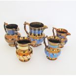 A collection of English copper lustre ceramic jugs H13-16cm, with faults. (5)