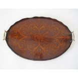 An English early 20th century mahogany and marquetry oval tray with brass handles. 60X39cm