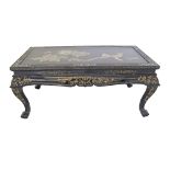 A Chinese black lacquer, painted and mother of pearl inlaid coffee table with collapsible legs.
