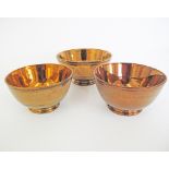 A collection of English copper lustre ceramic bowls W14-17cm. (3)