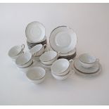 A set of 12 vintage "MZ"Czechoslovakian white porcelain tea cups and saucers with silver trimming,