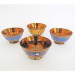 A collection of English copper lustre ceramic bowls W14-15cm. (4)