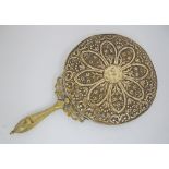 A gilt brass mounted round mirror c19th century with repousse and engraved decorations. L32cm,